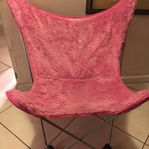 Two pink fuzzy lounge chairs. In good condition.